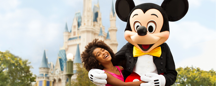 Mickey Mouse in front of Cinderella castle in walt disney world florida